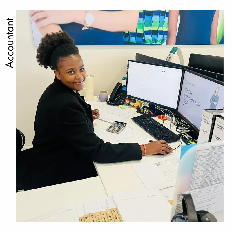 Nolu Mzi, accountant and finance professional, working at her desk in an office.