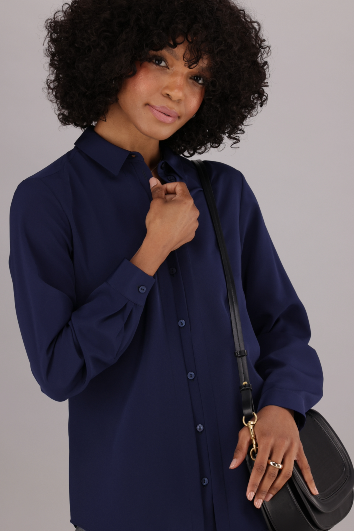 A Woman's Navy Long-Sleeved Shirt with Collar and Button Stand with Pintuck Detail. Available from ImNow.