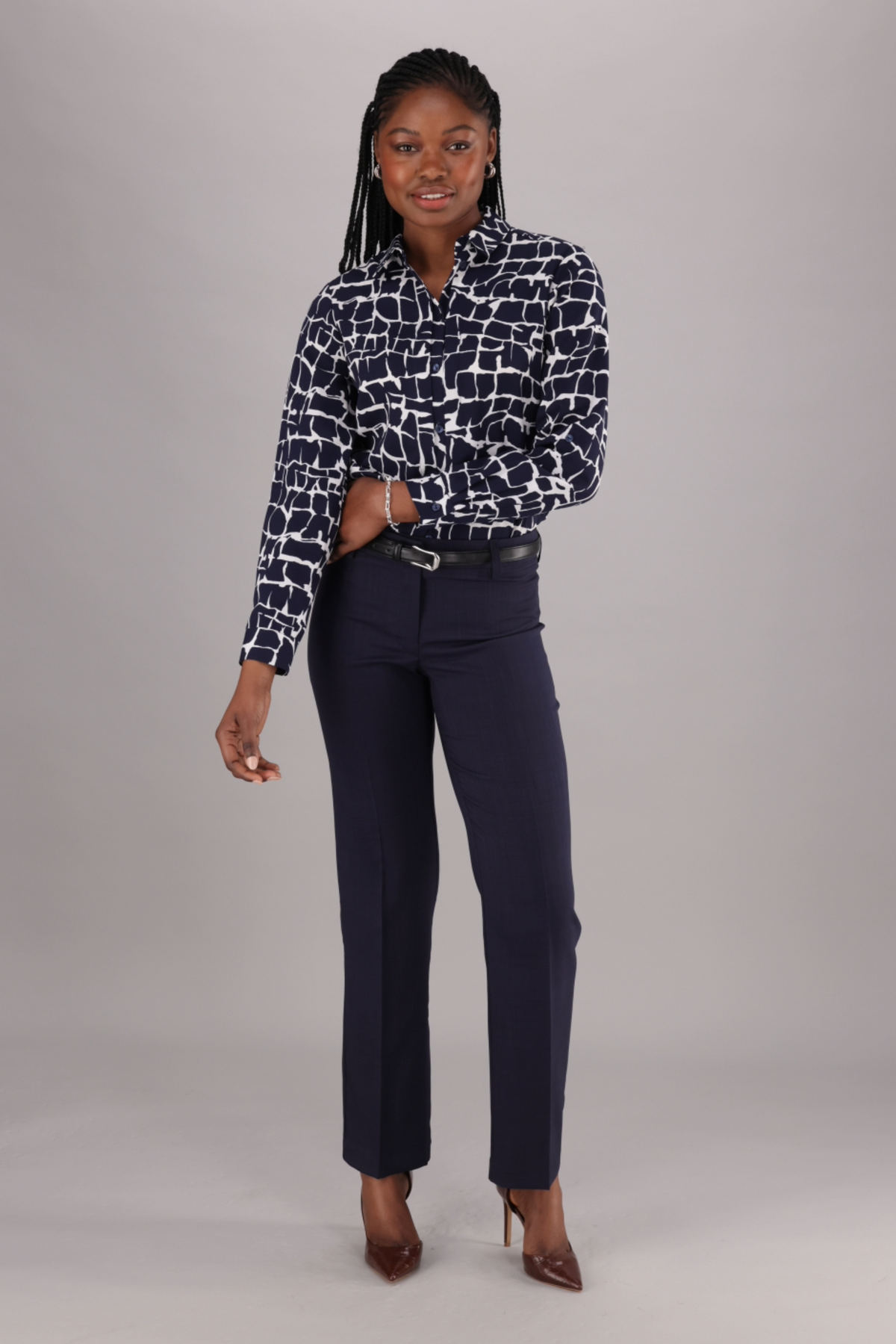 ImNow Women’s Blouse includes a Button Front, Pintucks and Tab sleeves in a Navy and White Print.