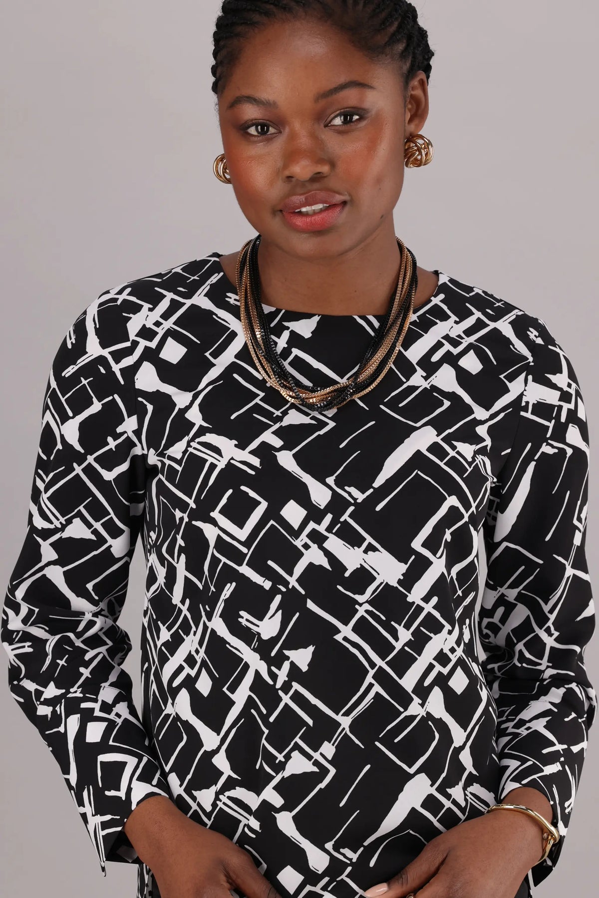 Corporate wear ladies round neck top for office in monochrome print.