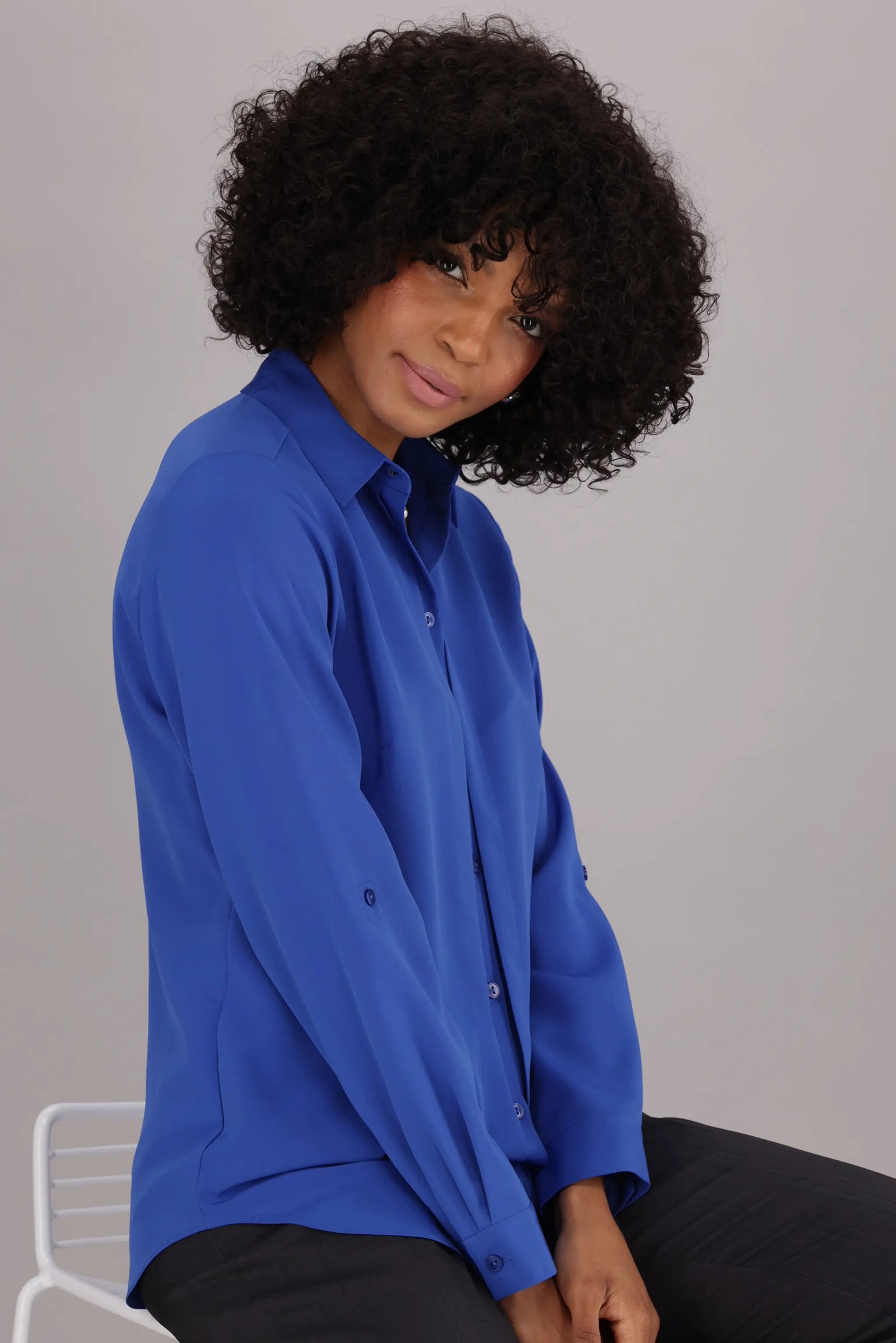 Women’s ImNow Long Sleeve with Tab Work Shirt featuring a Collar, Button down Front and Pintuck Detail in Blue.
