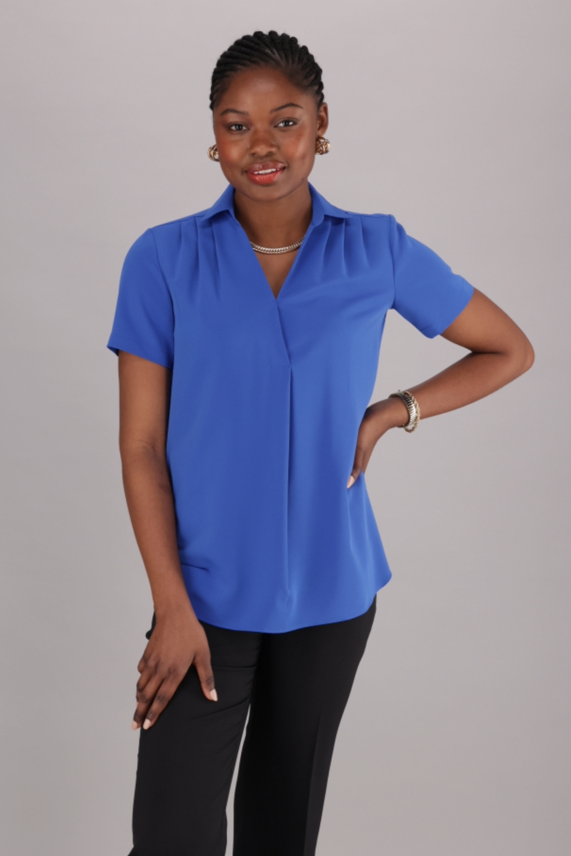 ImNow A bright blue V-neck blouse with short sleeves and a collared neckline.