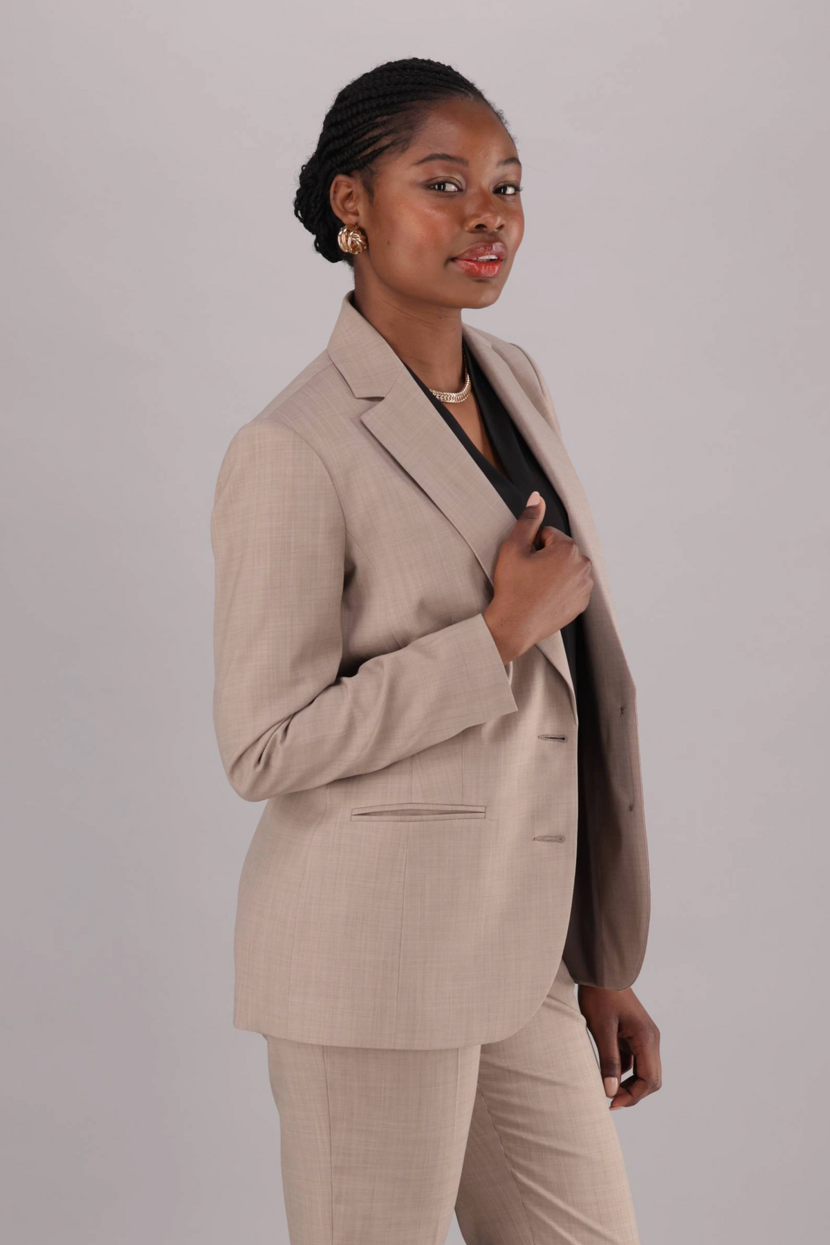 Women's stone blazer , longer length with lapels and jet pockets.