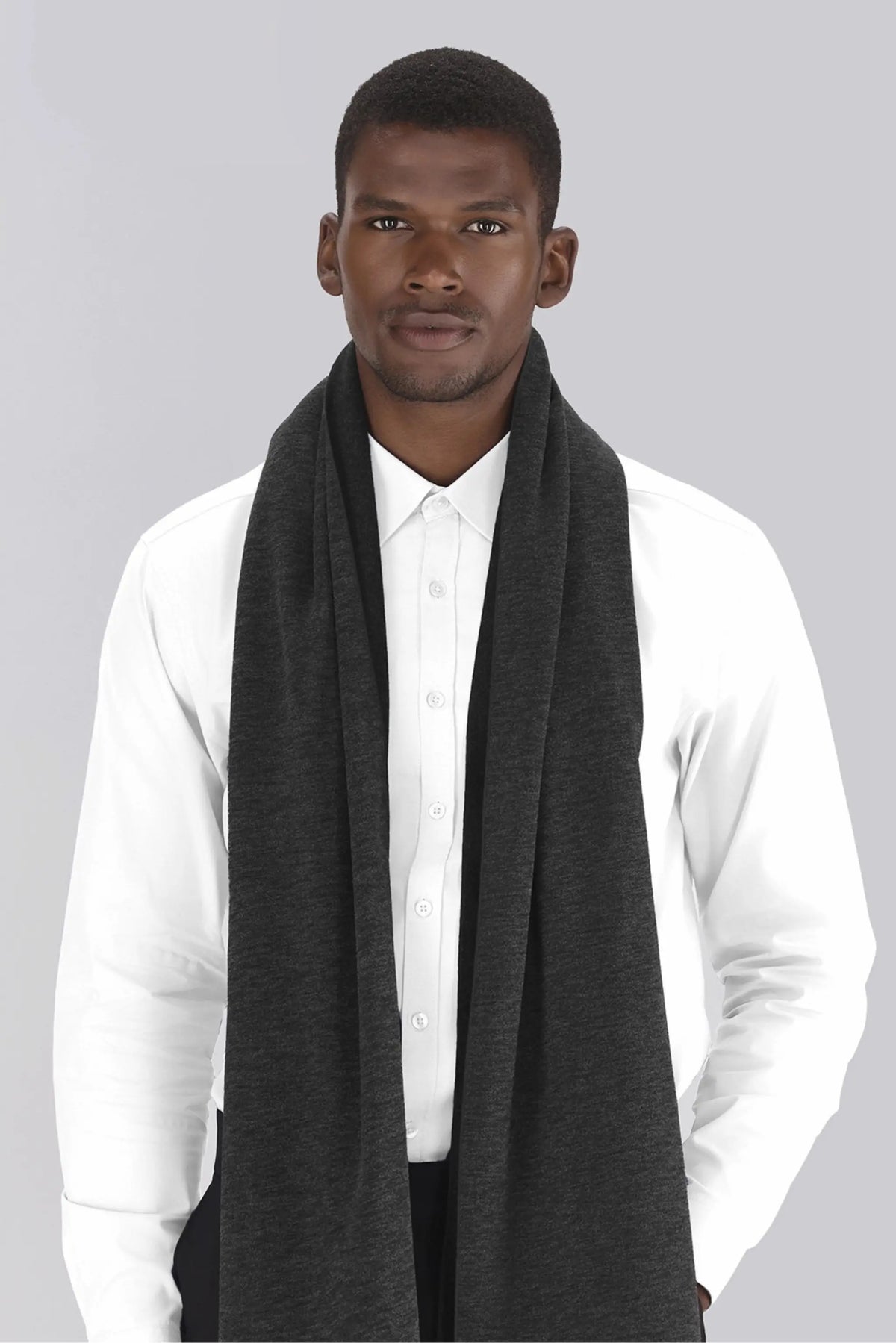 Male model wearing a dark grey chunky knit scarf draped around the shoulders by ImNow.