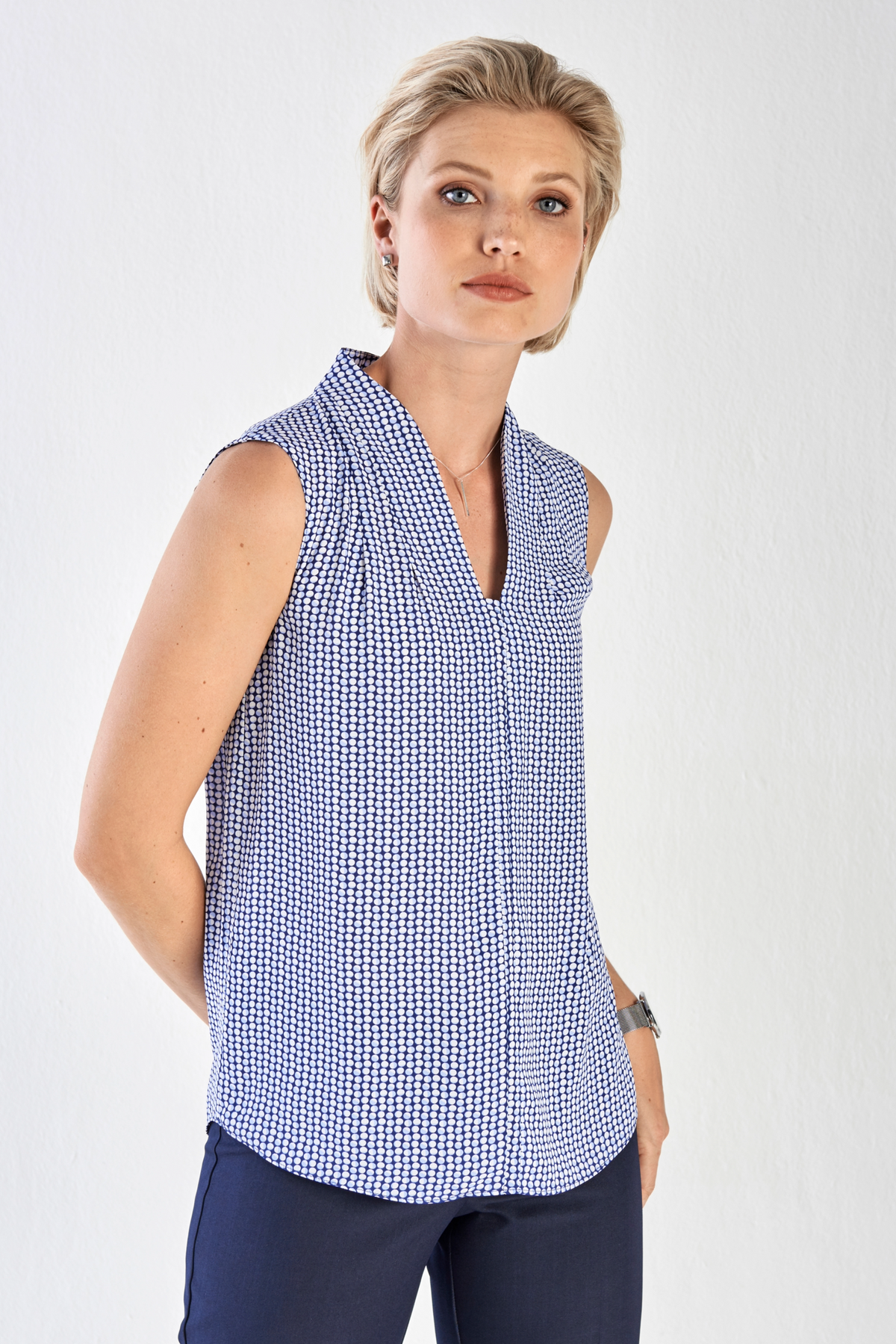 Womens Sleeveless Work Blouse in a Blue and White Print with Rounded Hem by ImNow. 