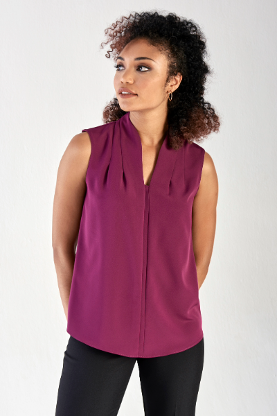 Smart sleeveless ladies’ blouse worn with black formal pants