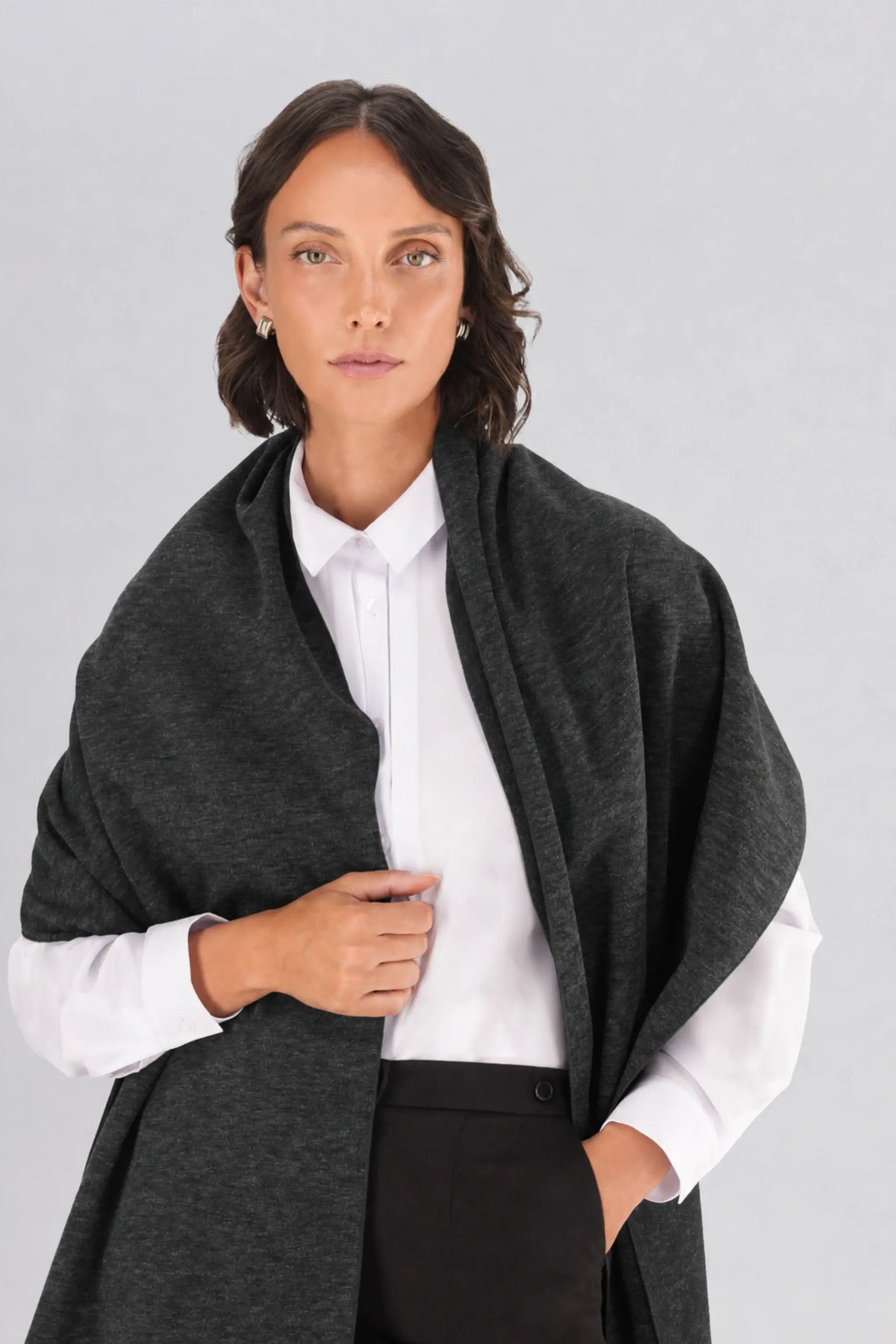 Dark grey chunky knit scarf worn by a model, showcasing an oversized winter scarf measuring 180cm.