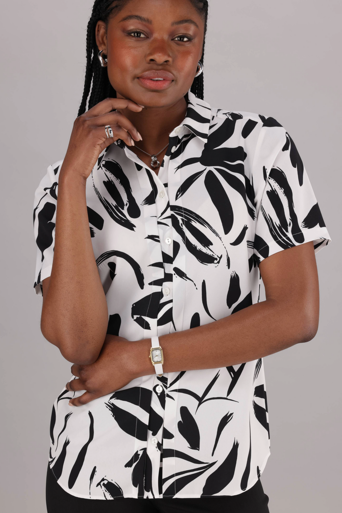 ImNow Women’s White and Black Print Short Sleeve Work Shirt. It has a Classic Button Front and Pintuck Detail.