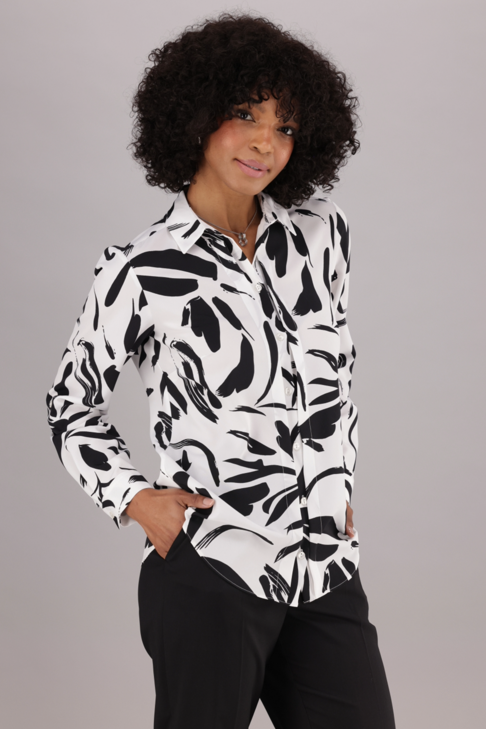 ImNow Women’s White and Black Print Long Sleeve Work Shirt. With a Classic Button Front and Pintuck Detail.