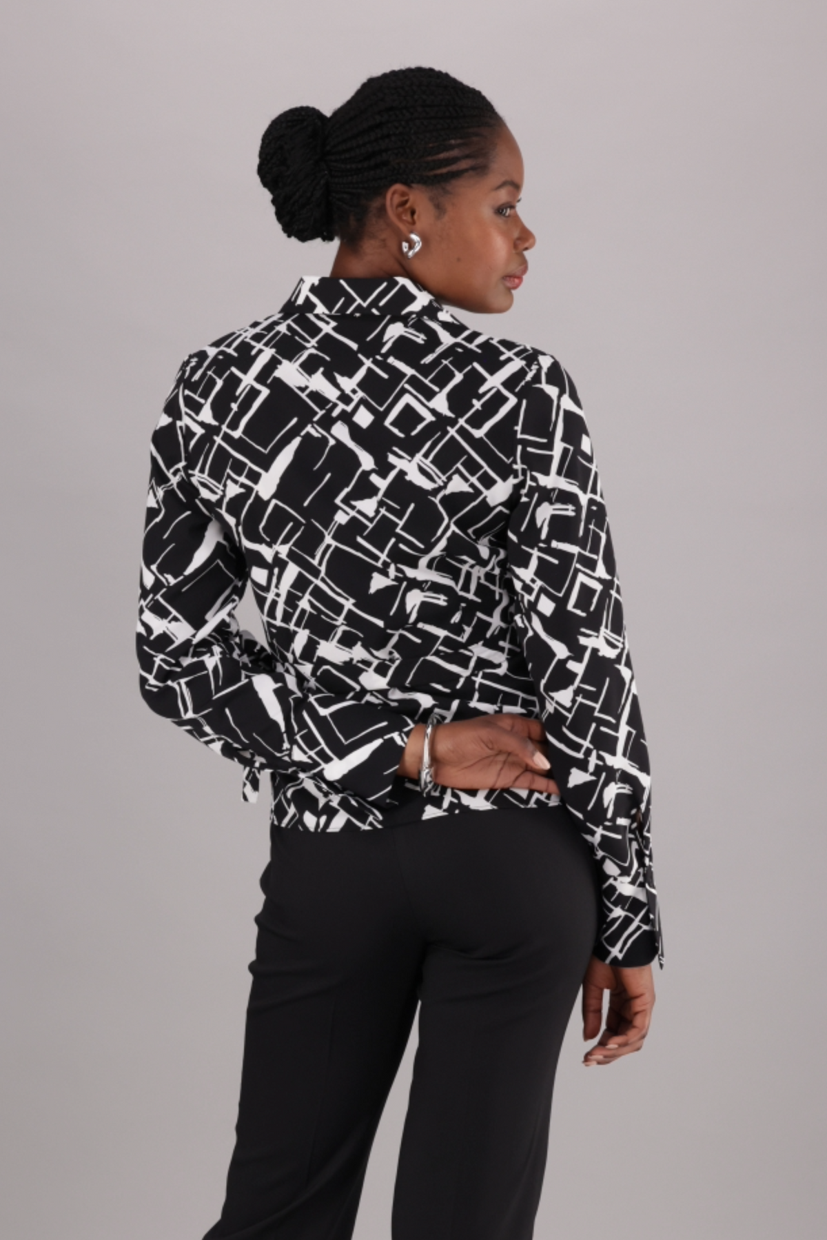 ImNow Black and white Printed Women’s Wrap-style Shirt with a V-neck, classic collar and wide cuff detail. 
